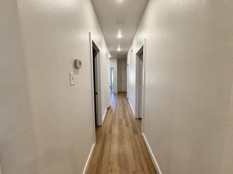 5711 Kemper Street, Unit B Lubbock, TX 79416 - Photo 16 of 20 a view of a hallway with wooden floor