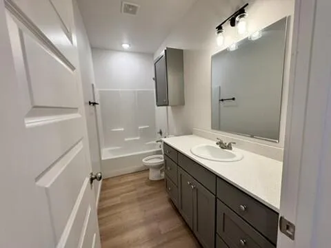 a bathroom with a double vanity sink toilet mirror and shower