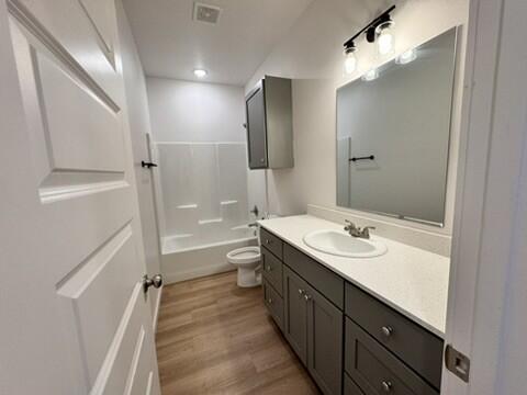 5711 Kemper Street, Unit B Lubbock, TX 79416 - Photo 17 of 20 a bathroom with a double vanity sink toilet mirror and shower
