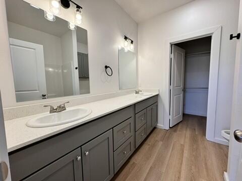 5711 Kemper Street, Unit B Lubbock, TX 79416 - Photo 10 of 20 a bathroom with a double vanity sink and mirror