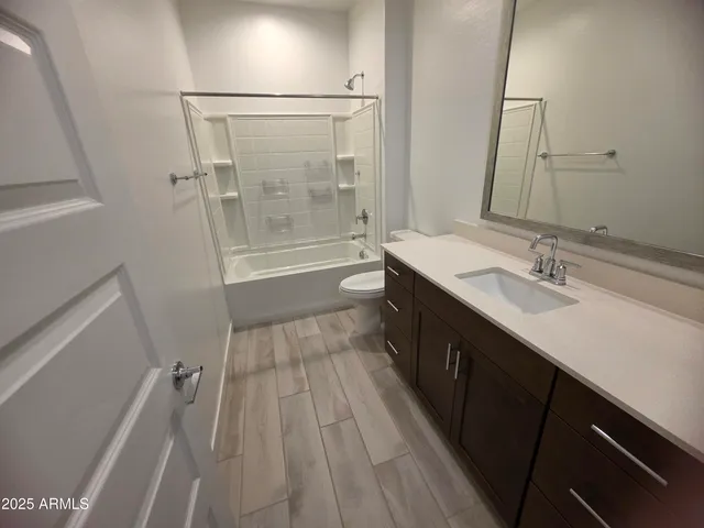 a spacious bathroom with a double vanity sink a mirror and a shower