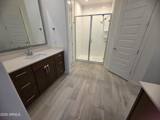 a bathroom with a sink a mirror and a toilet