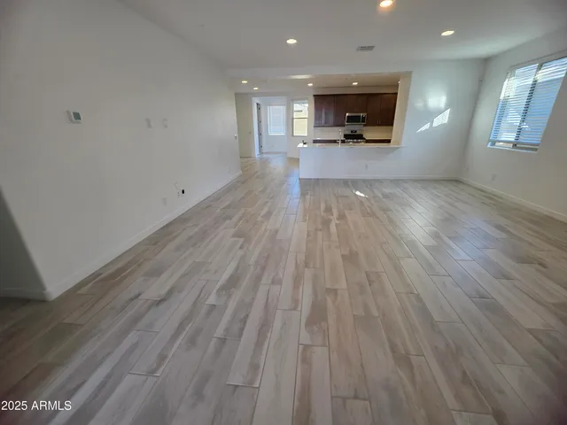 a view of a living room hardwood floor and a ceiling fan