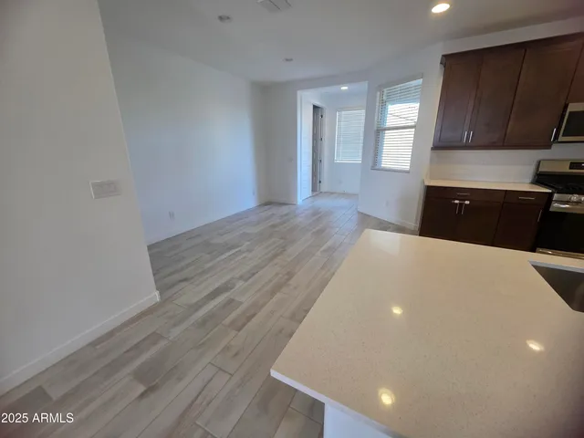 a view of a kitchen with a sink and dishwasher wooden floor