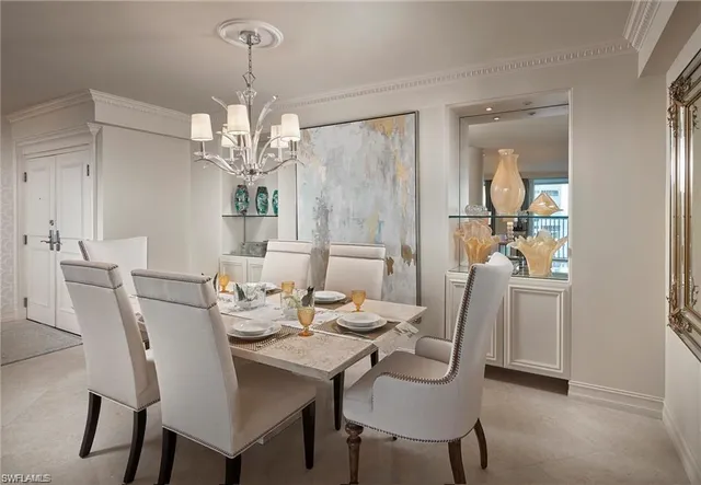 a view of a dining room with furniture and chandelier