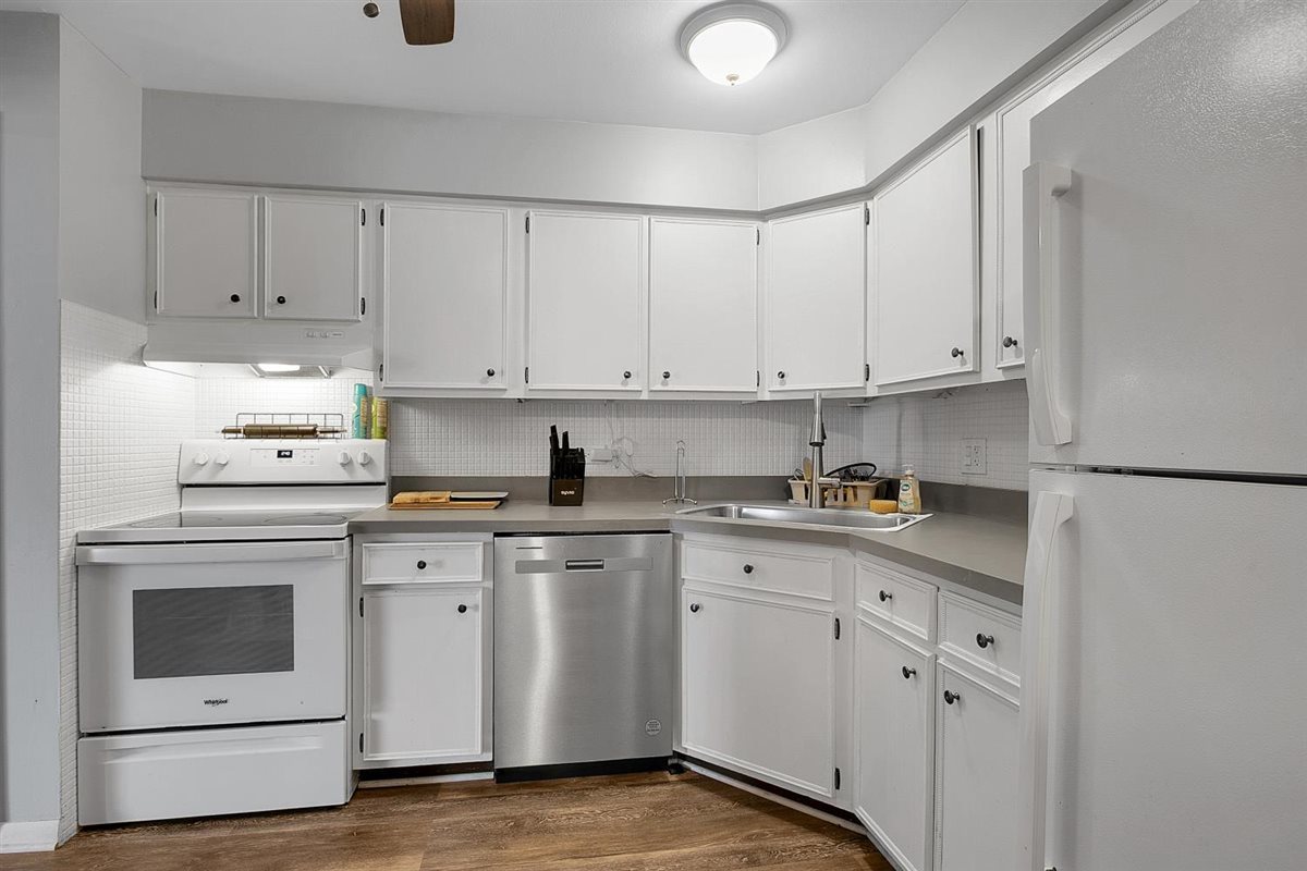 850 South Lorraine Road, Unit 3B Wheaton, IL 60189 - Photo 17 of 33 a kitchen with white cabinets stainless steel appliances and sink