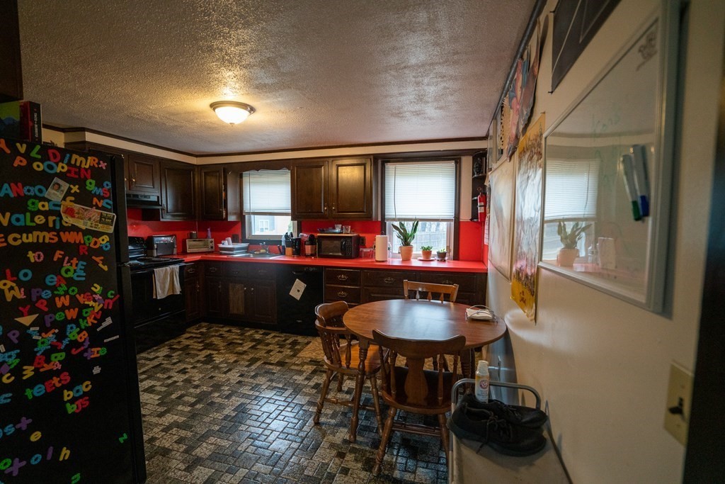 115 Belchertown Road Amherst, MA 01002 - Photo 7 of 18 a kitchen with a table and chairs in it