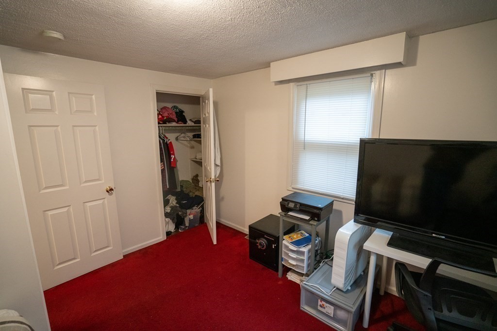 115 Belchertown Road Amherst, MA 01002 - Photo 10 of 18 a room with furniture and a flat screen tv