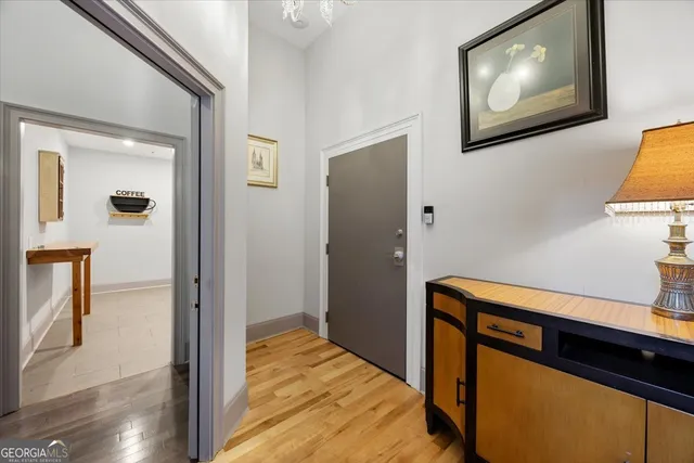 a view of a hallway with wooden floor and staircase