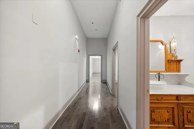 a view of hallway with wooden floor