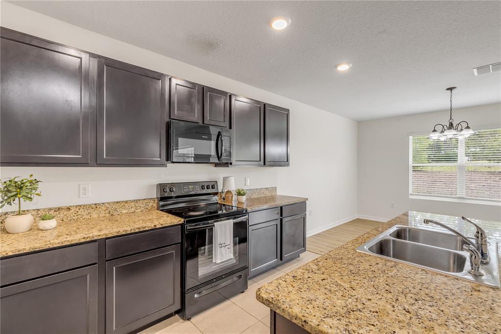 48 Hickory Loop Ocala, FL 34472 - Photo 17 of 52 a kitchen with stainless steel appliances granite countertop a sink stove and cabinets
