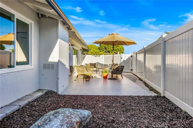 a view of a backyard with a patio and dining space