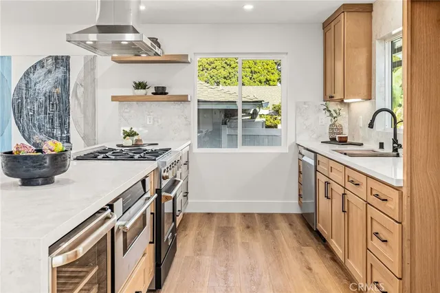 a kitchen with a sink stove and cabinets