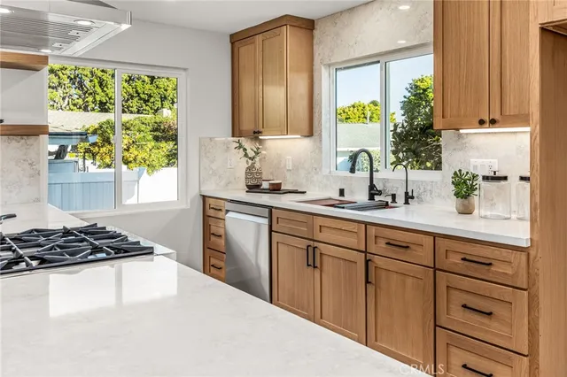 a kitchen with appliances cabinets and a large window