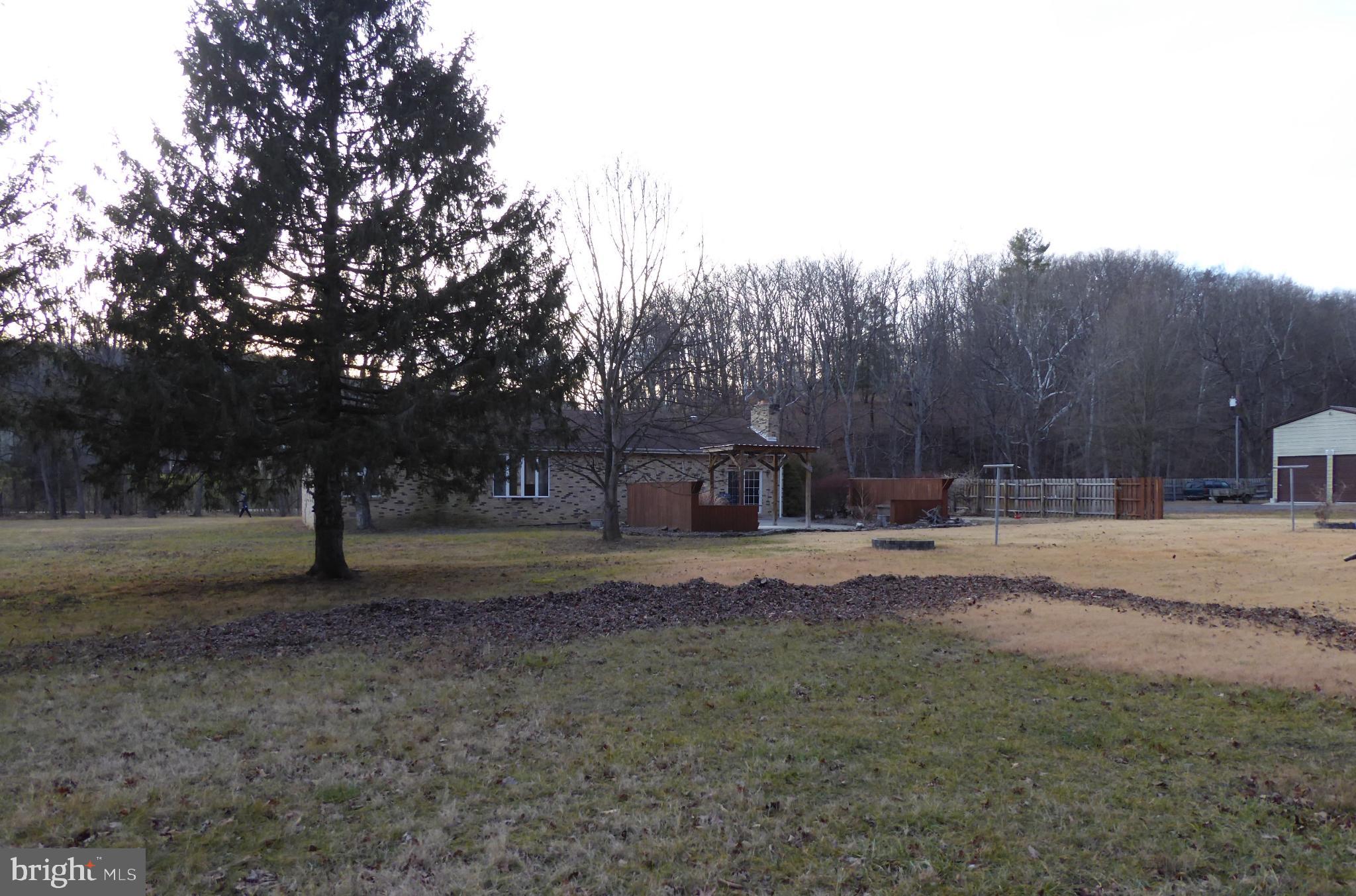 102 Dry Run Road Burlington, WV 26710 - Photo 13 of 85 Serene landscape with a charming home backdrop.