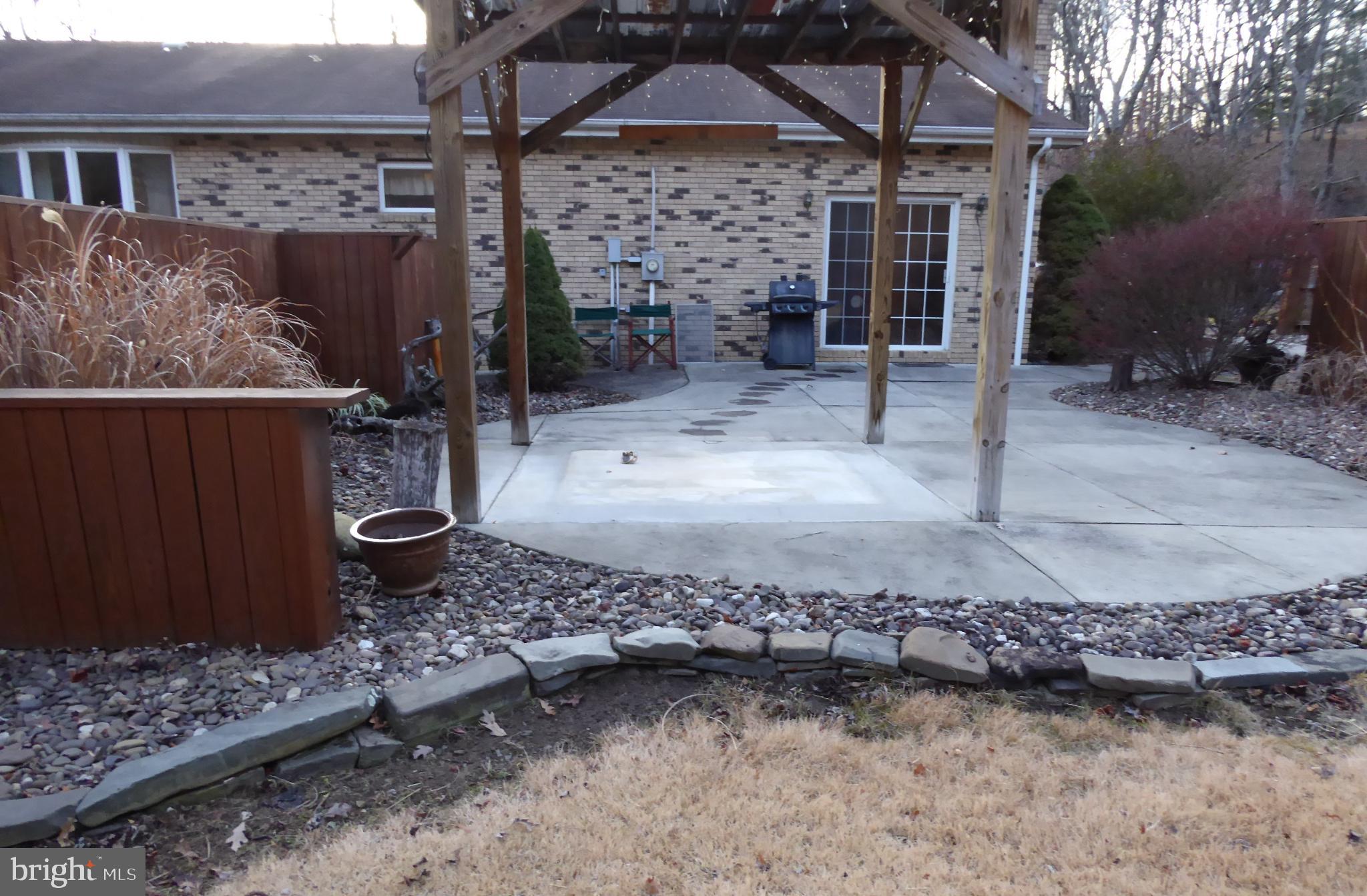 102 Dry Run Road Burlington, WV 26710 - Photo 16 of 85 Serene backyard retreat with stone accents.