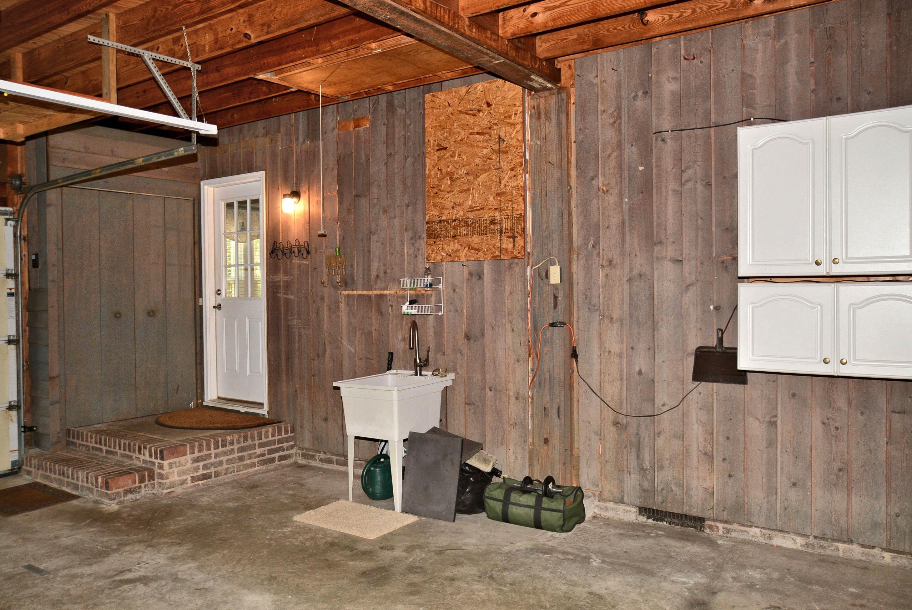 7409 Peppercorn Court Raleigh, NC 27613 - Photo 30 of 47 Garage Utility Sink and Storage Closet by Kitchen Door