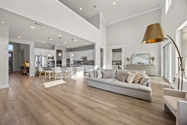 a kitchen with stainless steel appliances granite countertop a stove and white cabinets