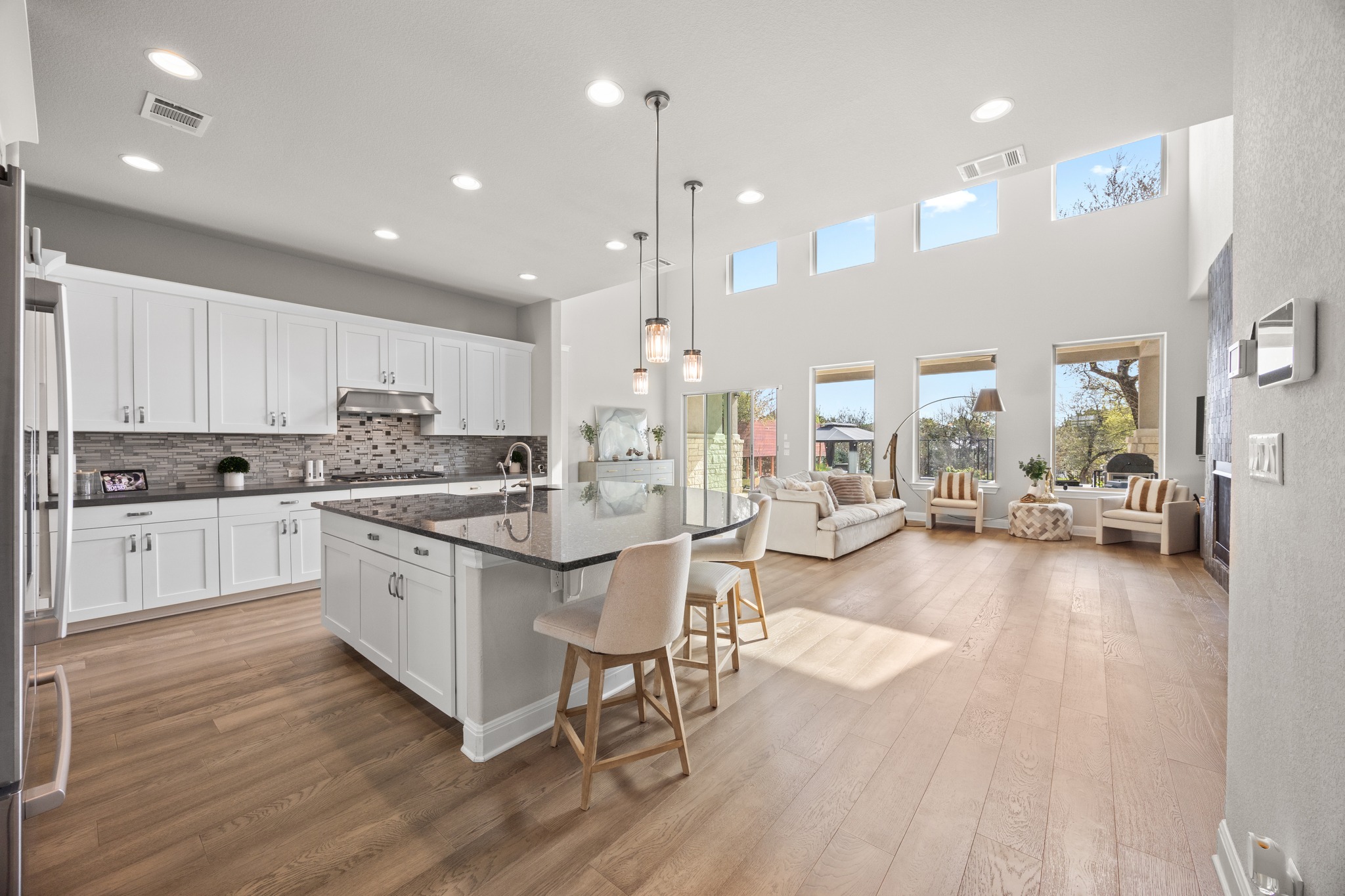 15705 Colinas Cove Bee Cave, TX 78738 - Photo 13 of 40 a large white kitchen with lots of counter space a sink and appliances