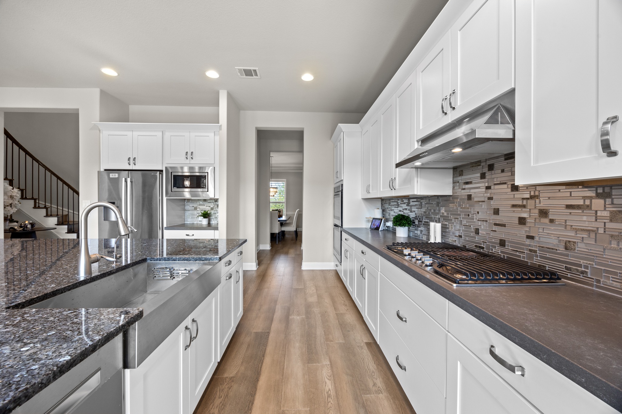 15705 Colinas Cove Bee Cave, TX 78738 - Photo 15 of 40 a large kitchen with stainless steel appliances granite countertop a lot of counter space and wooden floor