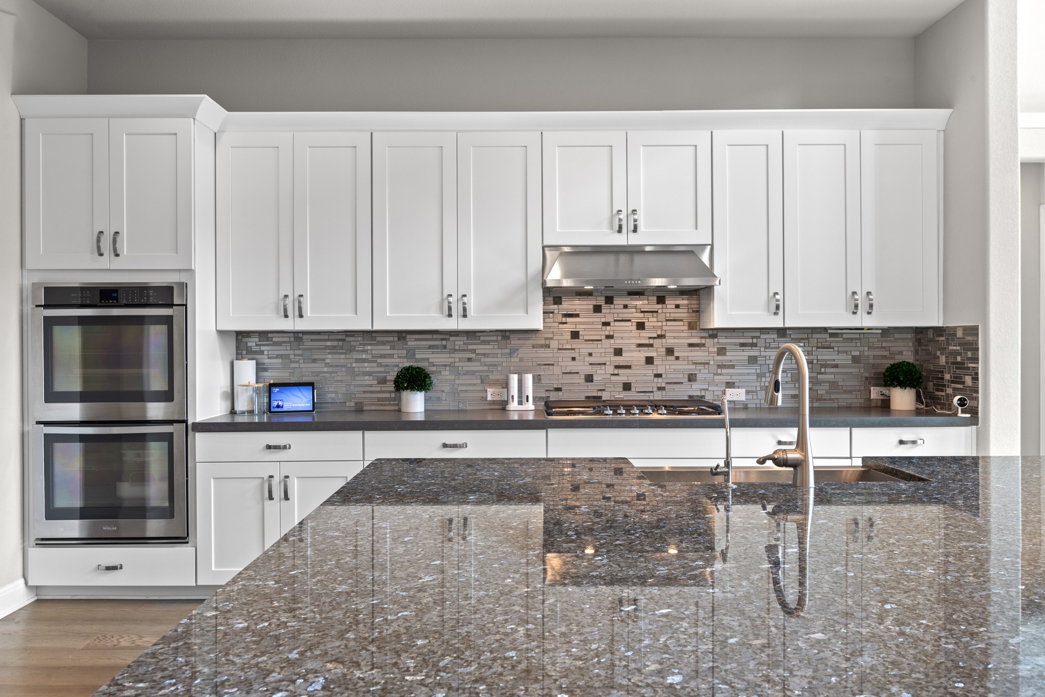 15705 Colinas Cove Bee Cave, TX 78738 - Photo 17 of 40 a kitchen with stainless steel appliances granite countertop a stove and white cabinets