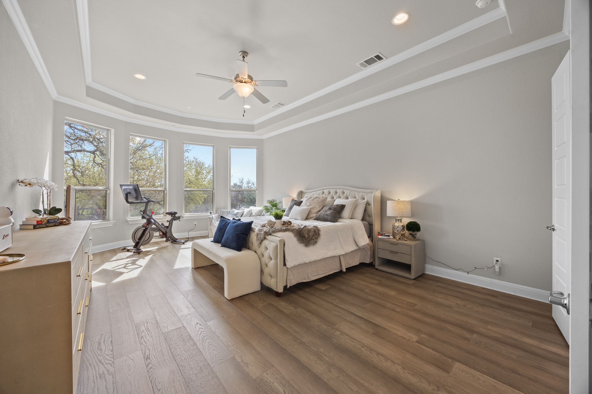 15705 Colinas Cove Bee Cave, TX 78738 - Photo 18 of 40 Bedroom with a raised ceiling, a ceiling fan, dark wood finished floors, recessed lighting, and ornamental molding