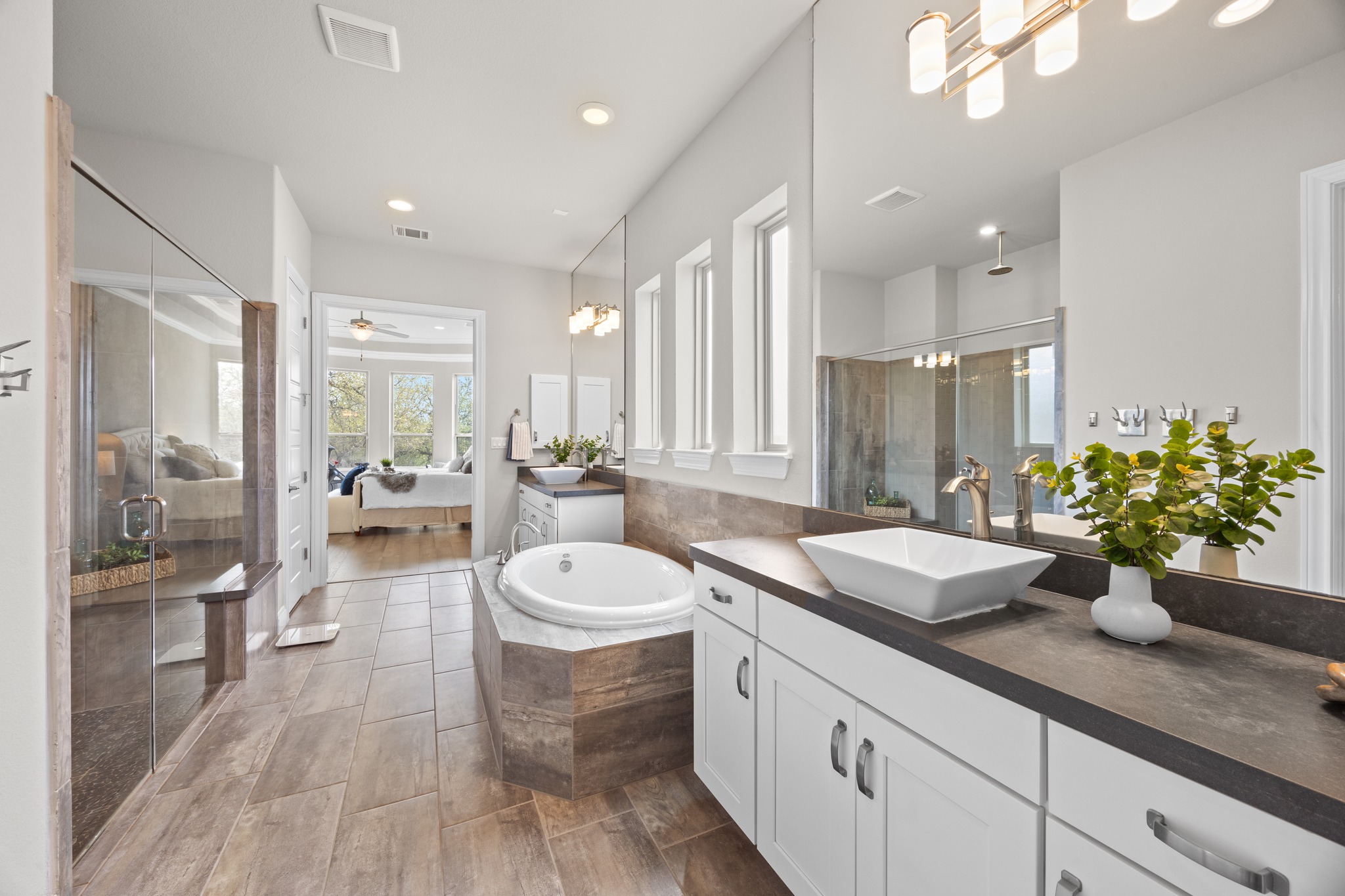 15705 Colinas Cove Bee Cave, TX 78738 - Photo 22 of 40 a spacious bathroom with a granite countertop sink mirror and a bathtub