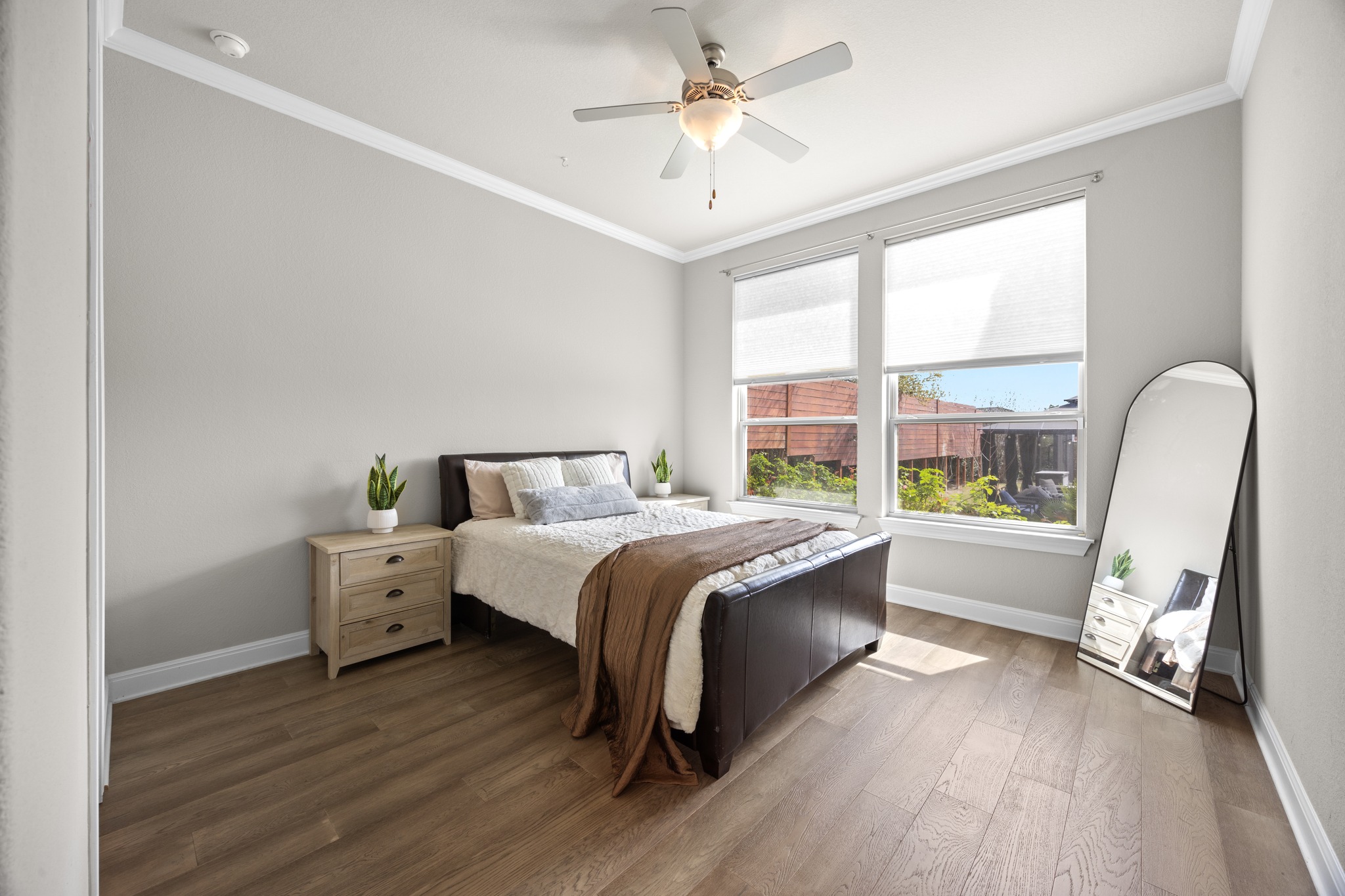15705 Colinas Cove Bee Cave, TX 78738 - Photo 24 of 40 a spacious bedroom with a bed and a large window