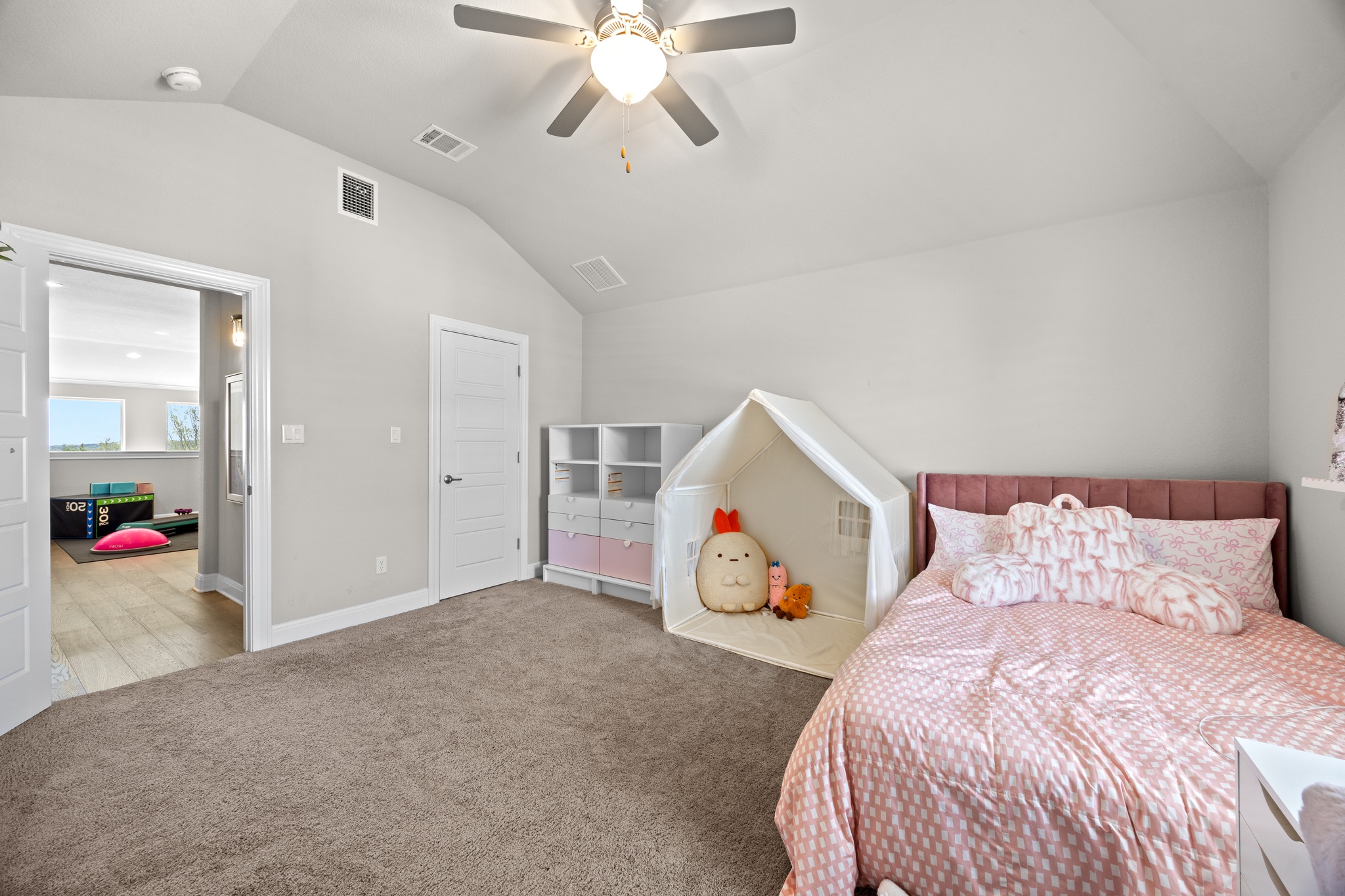 15705 Colinas Cove Bee Cave, TX 78738 - Photo 30 of 40 a bedroom with a bed and a chandelier