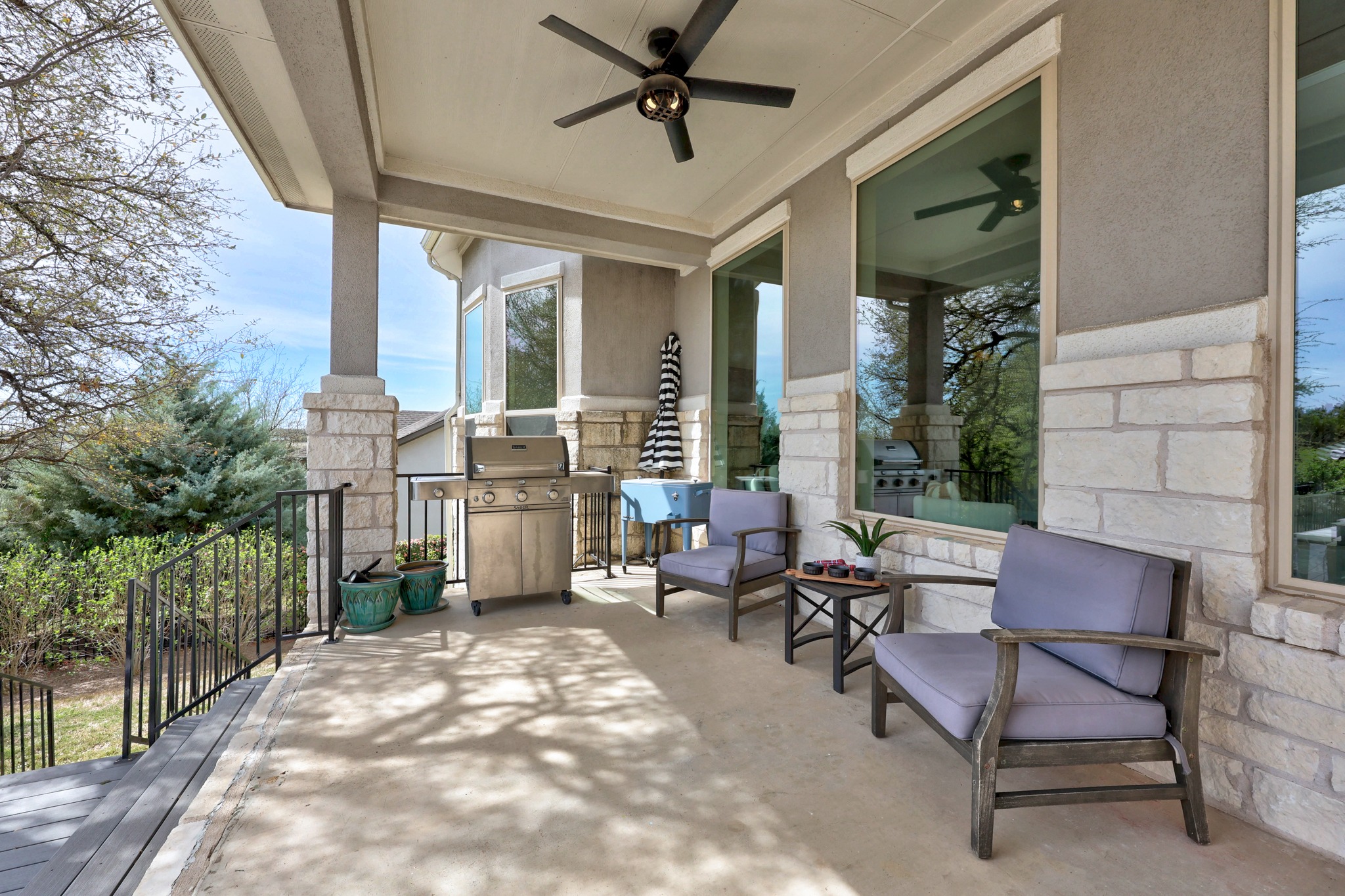 15705 Colinas Cove Bee Cave, TX 78738 - Photo 33 of 40 a living room with patio furniture and a floor to ceiling window