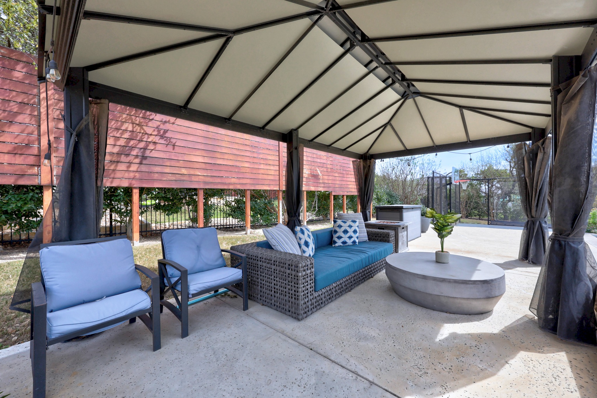 15705 Colinas Cove Bee Cave, TX 78738 - Photo 36 of 40 a view of patio with table and chairs under an umbrella