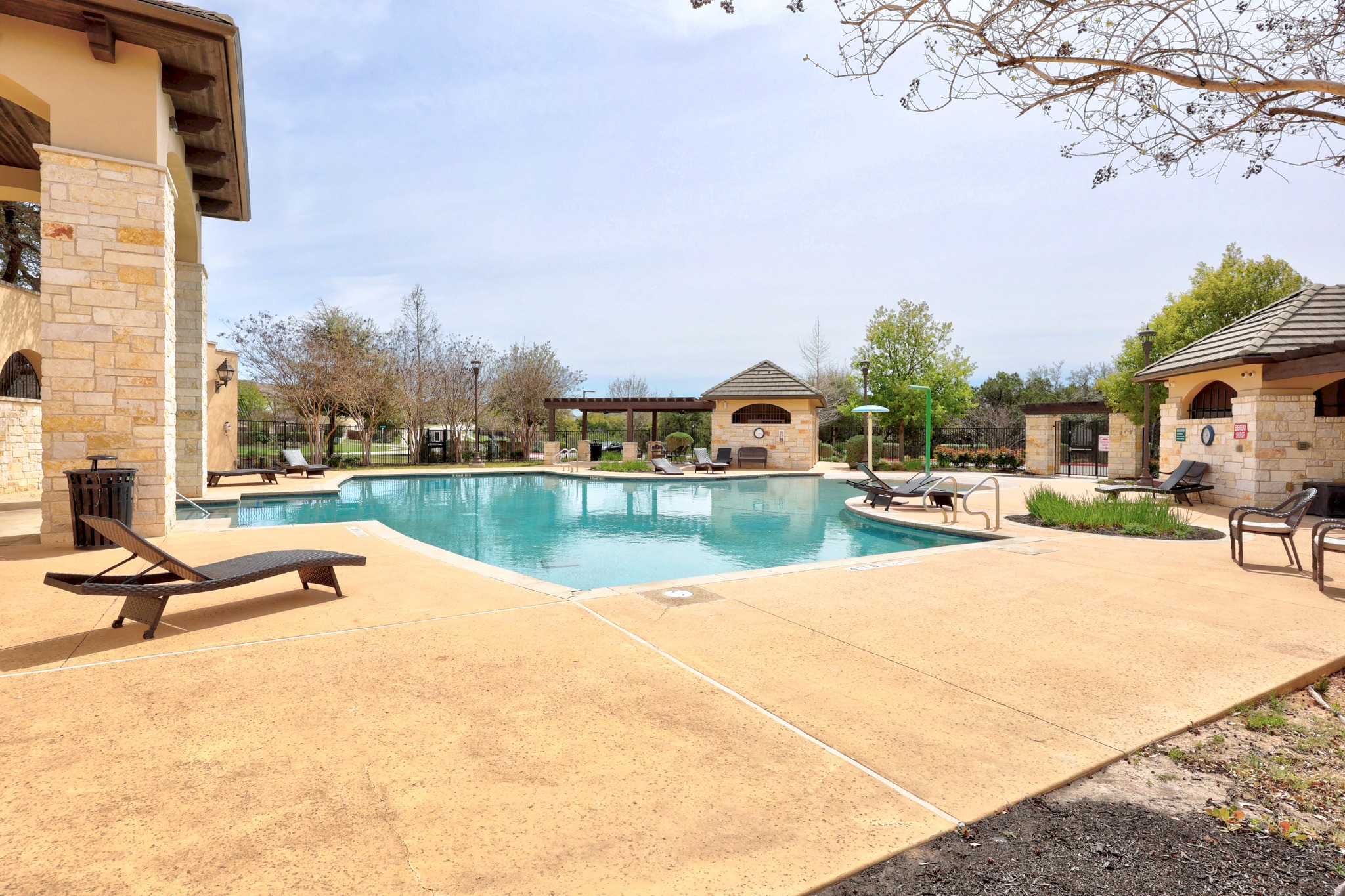 15705 Colinas Cove Bee Cave, TX 78738 - Photo 40 of 40 Community pool with a patio and an outdoor stone fireplace