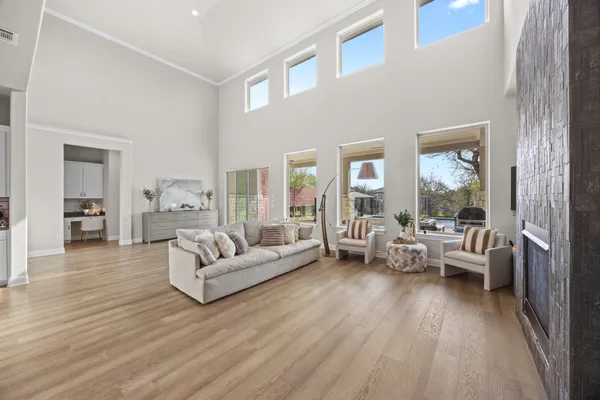 a living room with furniture and kitchen view