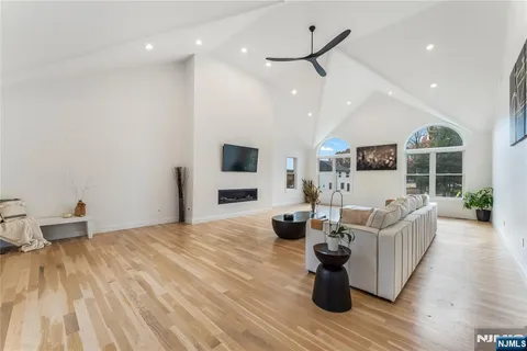 a living room with fireplace furniture and a wooden floor