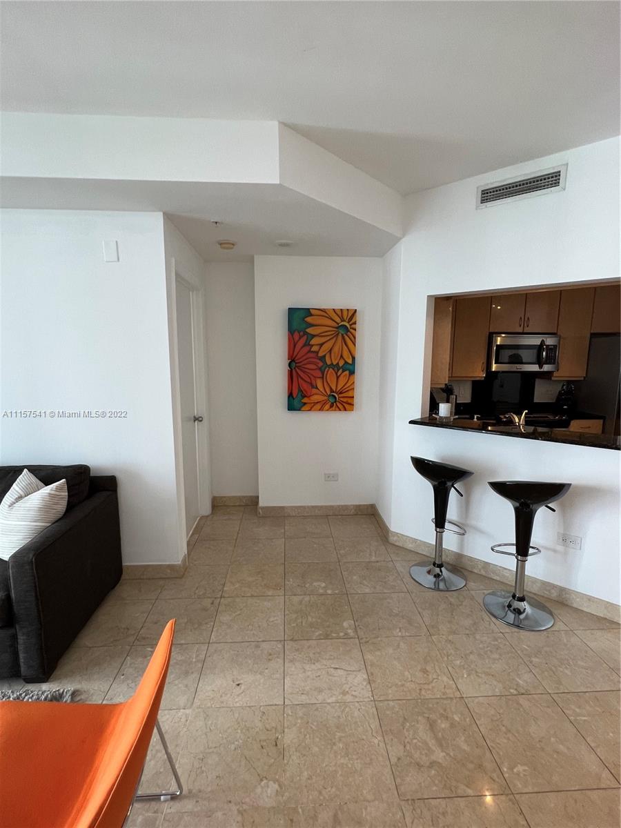 801 Brickell Key Boulevard, Unit 1506 Miami, FL 33131 - Photo 11 of 27 a view of a workspace with furniture