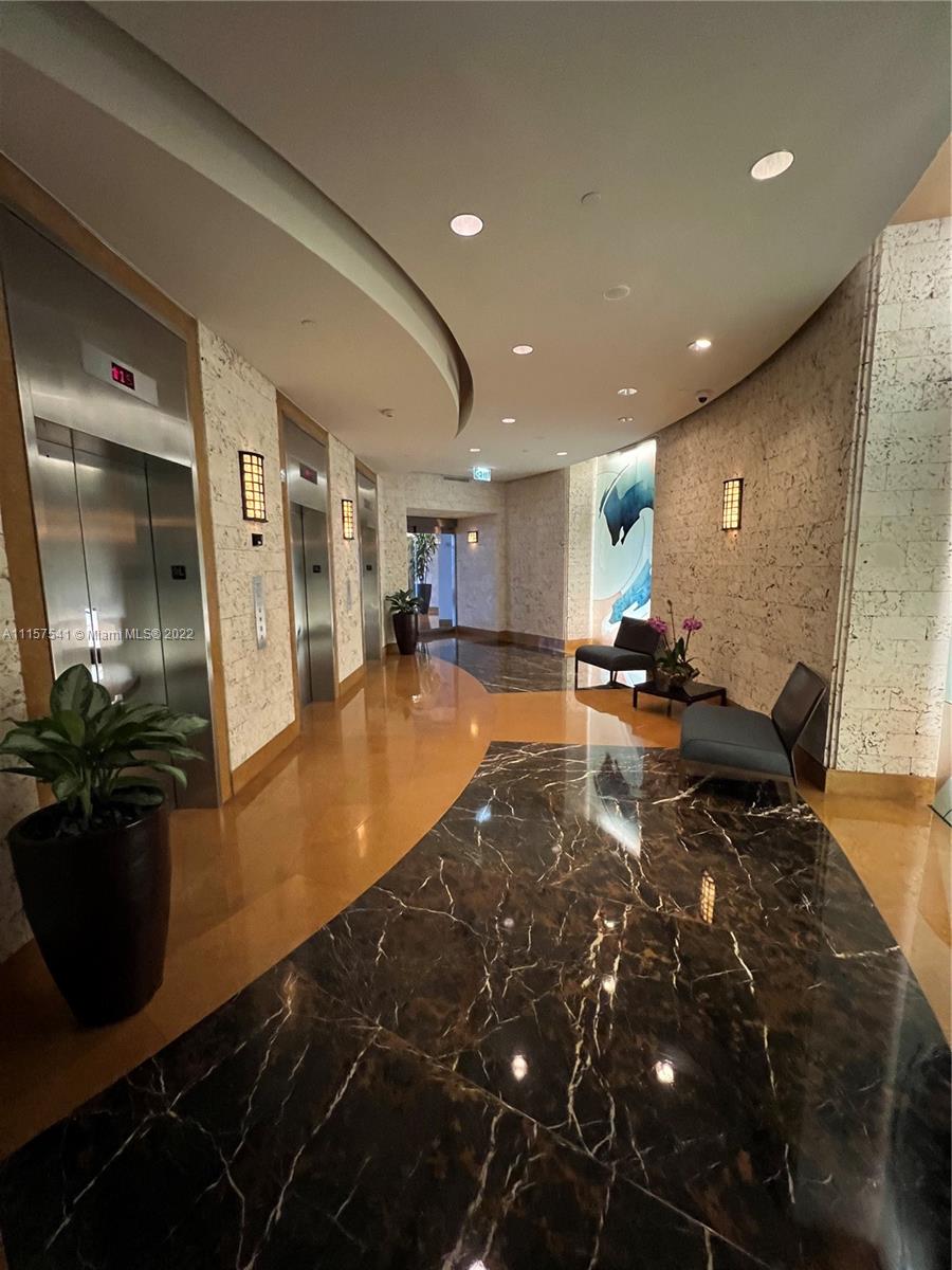 801 Brickell Key Boulevard, Unit 1506 Miami, FL 33131 - Photo 4 of 27 a lobby with furniture and a potted plant