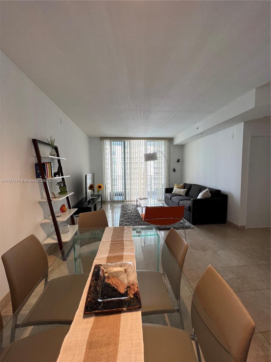 801 Brickell Key Boulevard, Unit 1506 Miami, FL 33131 - Photo 6 of 27 a living room with furniture