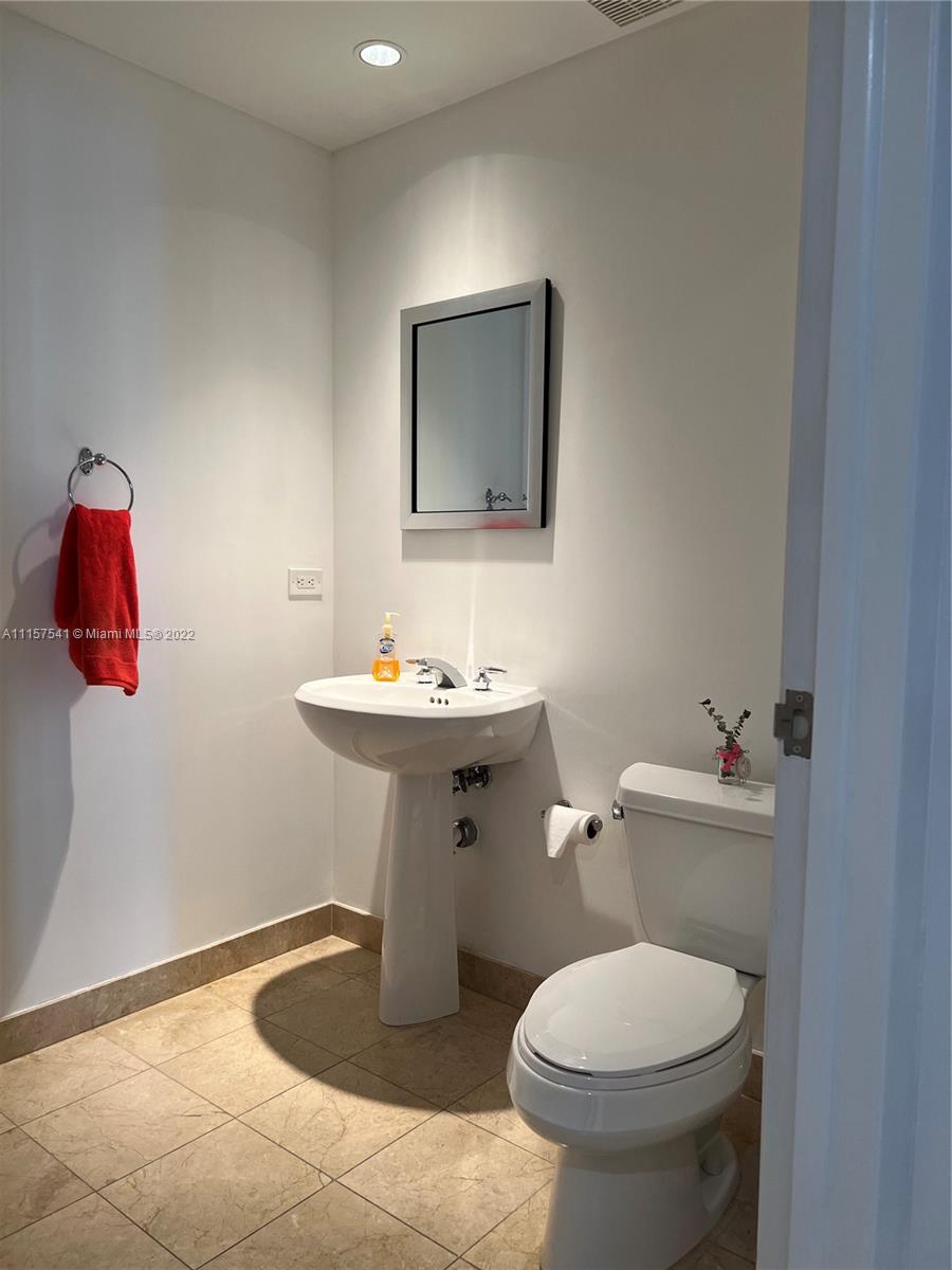 801 Brickell Key Boulevard, Unit 1506 Miami, FL 33131 - Photo 8 of 27 a bathroom with a sink toilet and mirror