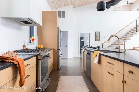 a kitchen with a sink refrigerator and cabinets