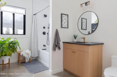 a dining room with furniture and a potted plant