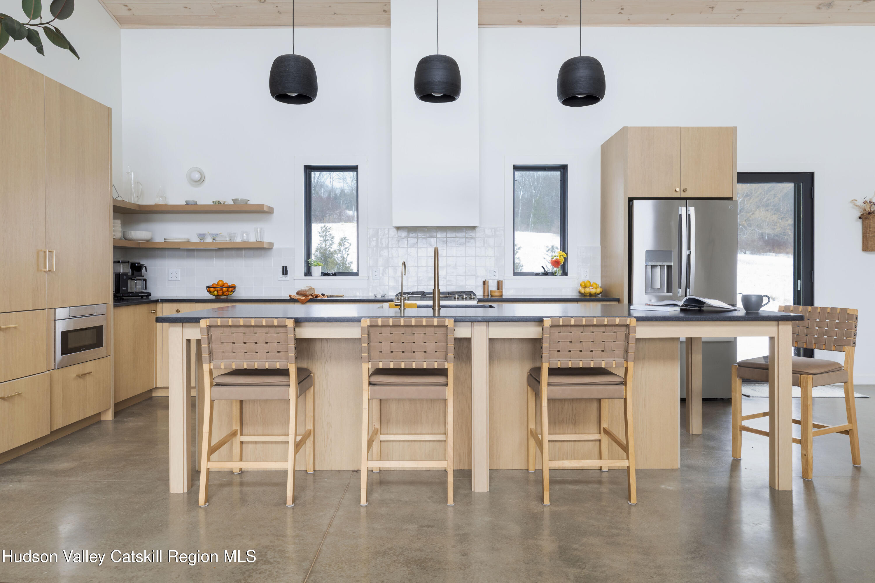 380 Decker Road Stamford, NY 12167 - Photo 3 of 31 a kitchen with stainless steel appliances granite countertop a stove top oven a sink a dining table and chairs with wooden floor