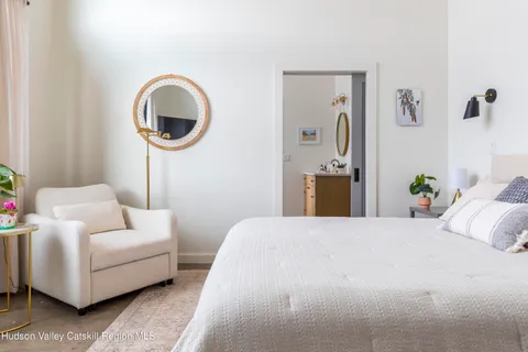 a bedroom with a bed and a couch