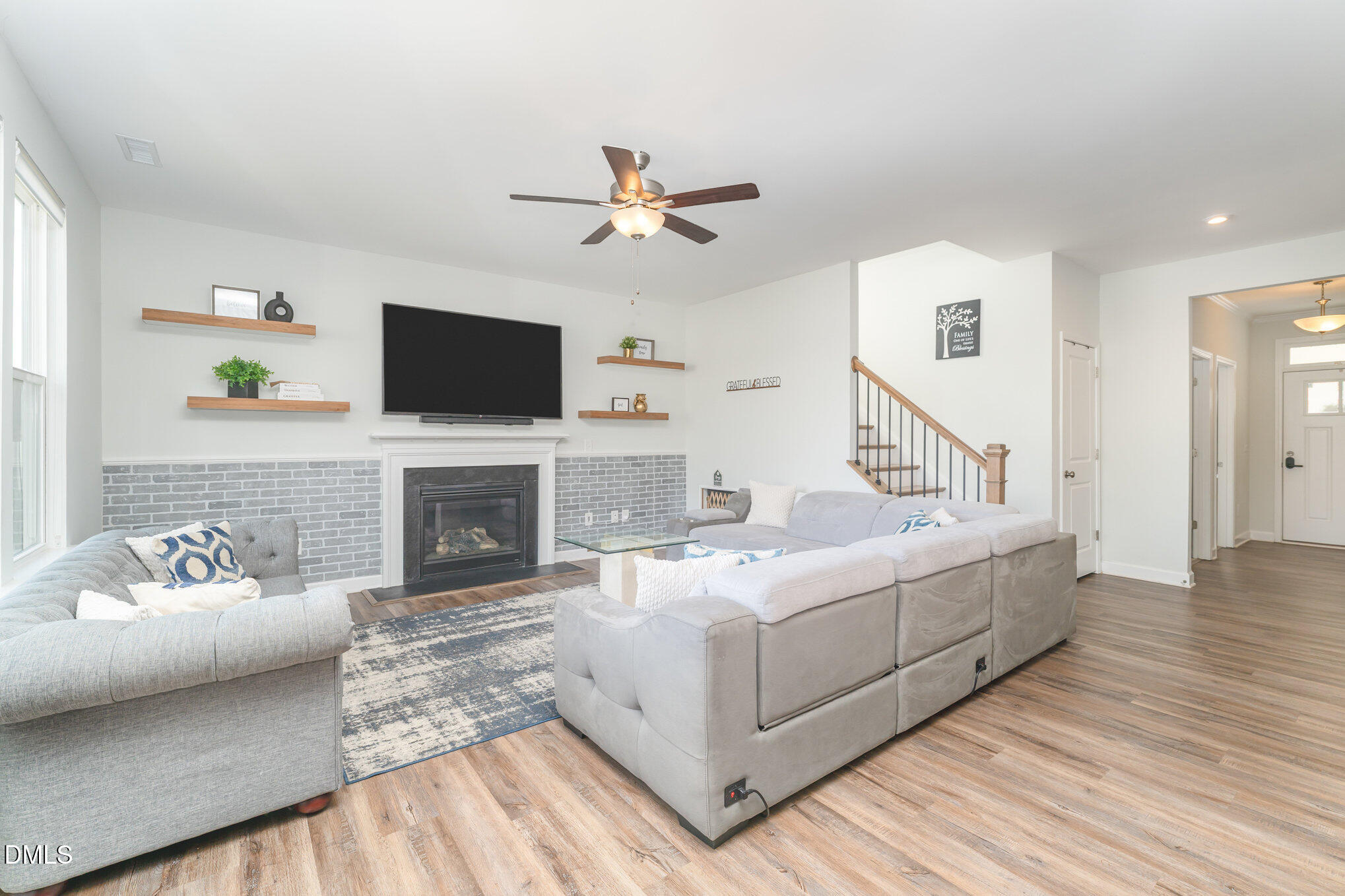 73 Lockhaven Drive Garner, NC 27529 - Photo 15 of 38 a living room with furniture a fireplace and a flat screen tv