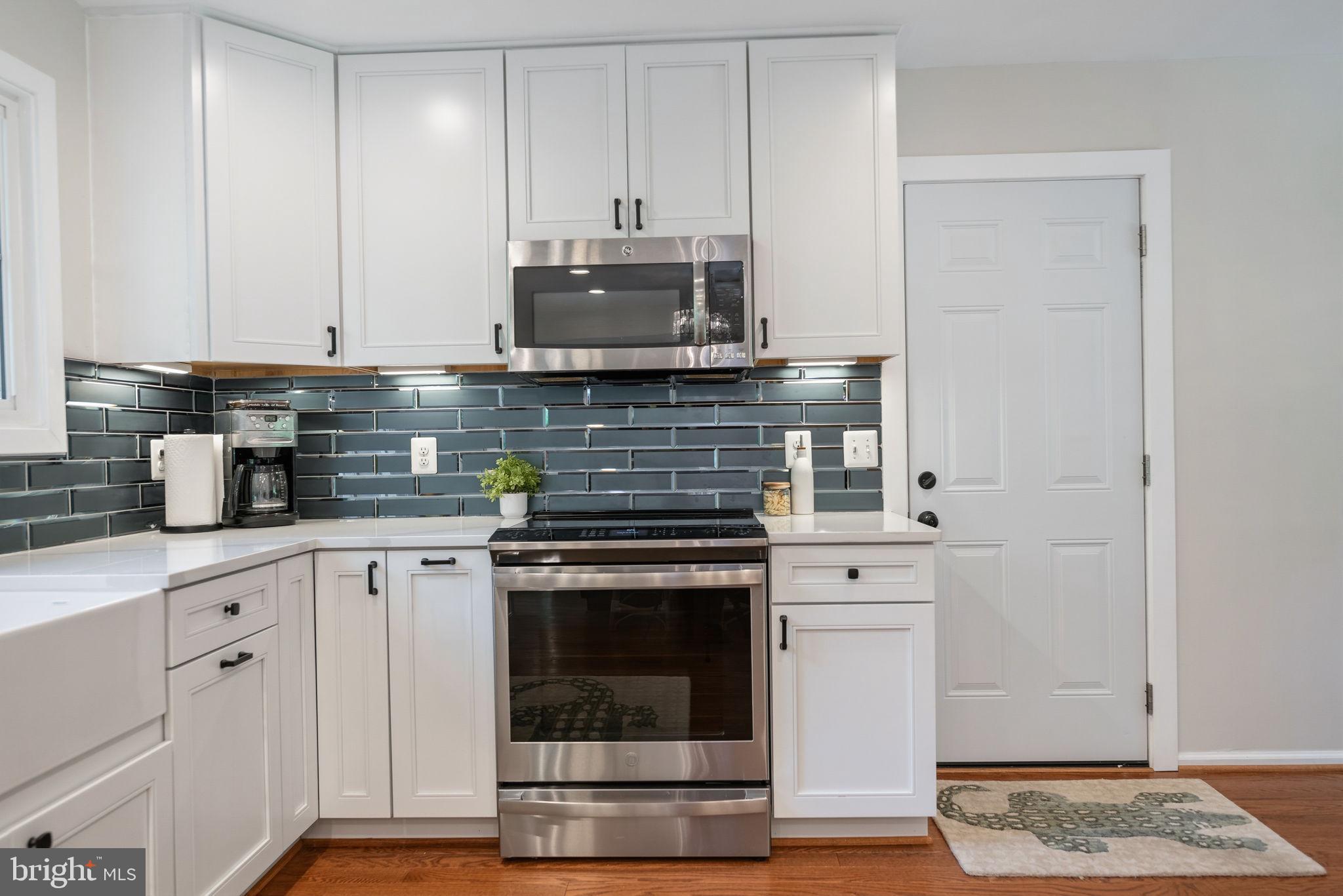 7603 Modisto Lane Springfield, VA 22153 - Photo 13 of 57 a kitchen with stainless steel appliances granite countertop a stove and a microwave