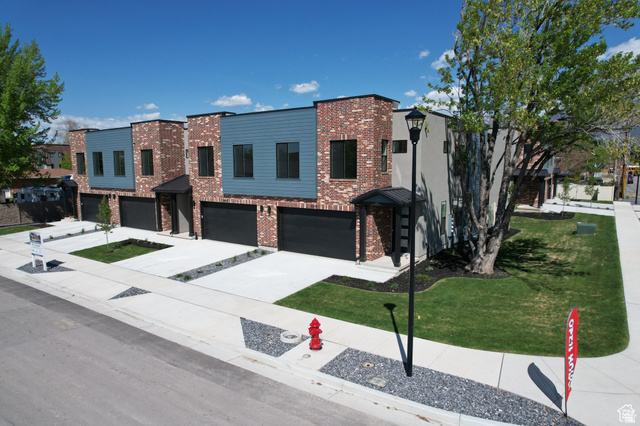 8087 South 615 East, Unit 3 Sandy, UT 84070 - Photo 1 of 23 Contemporary townhome exteriors featuring brick and horizontal siding accents