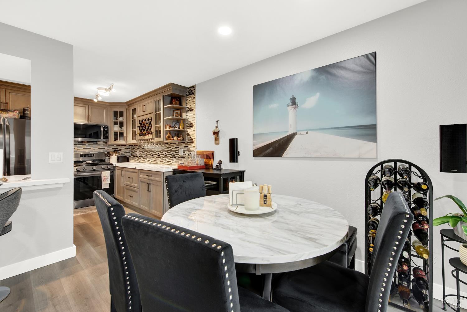 216 Apollo, Unit 7 Hercules, CA 94547 - Photo 11 of 29 a kitchen with stainless steel appliances granite countertop a table chairs and a refrigerator