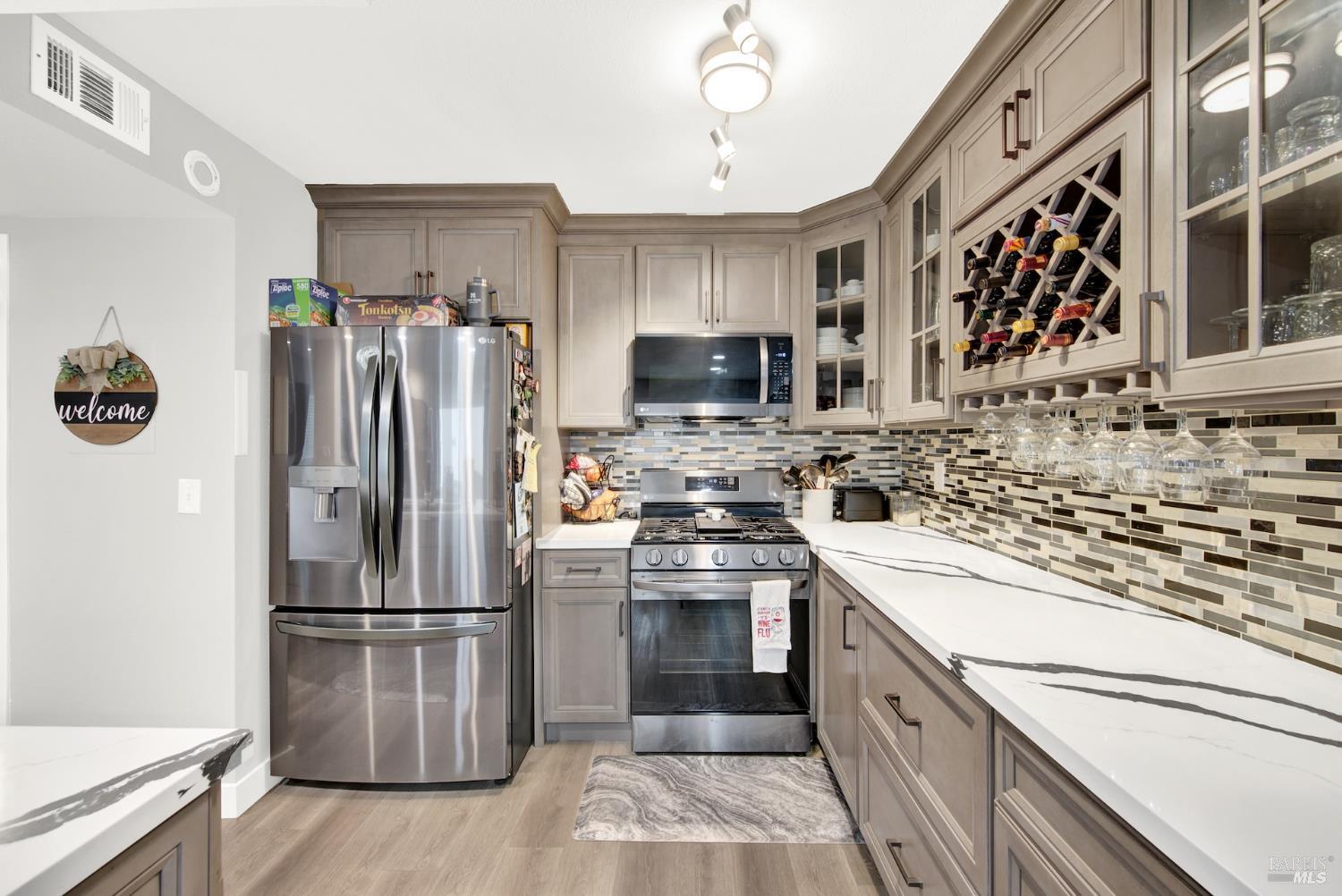 216 Apollo, Unit 7 Hercules, CA 94547 - Photo 13 of 29 a kitchen with a refrigerator sink and stainless steel appliances
