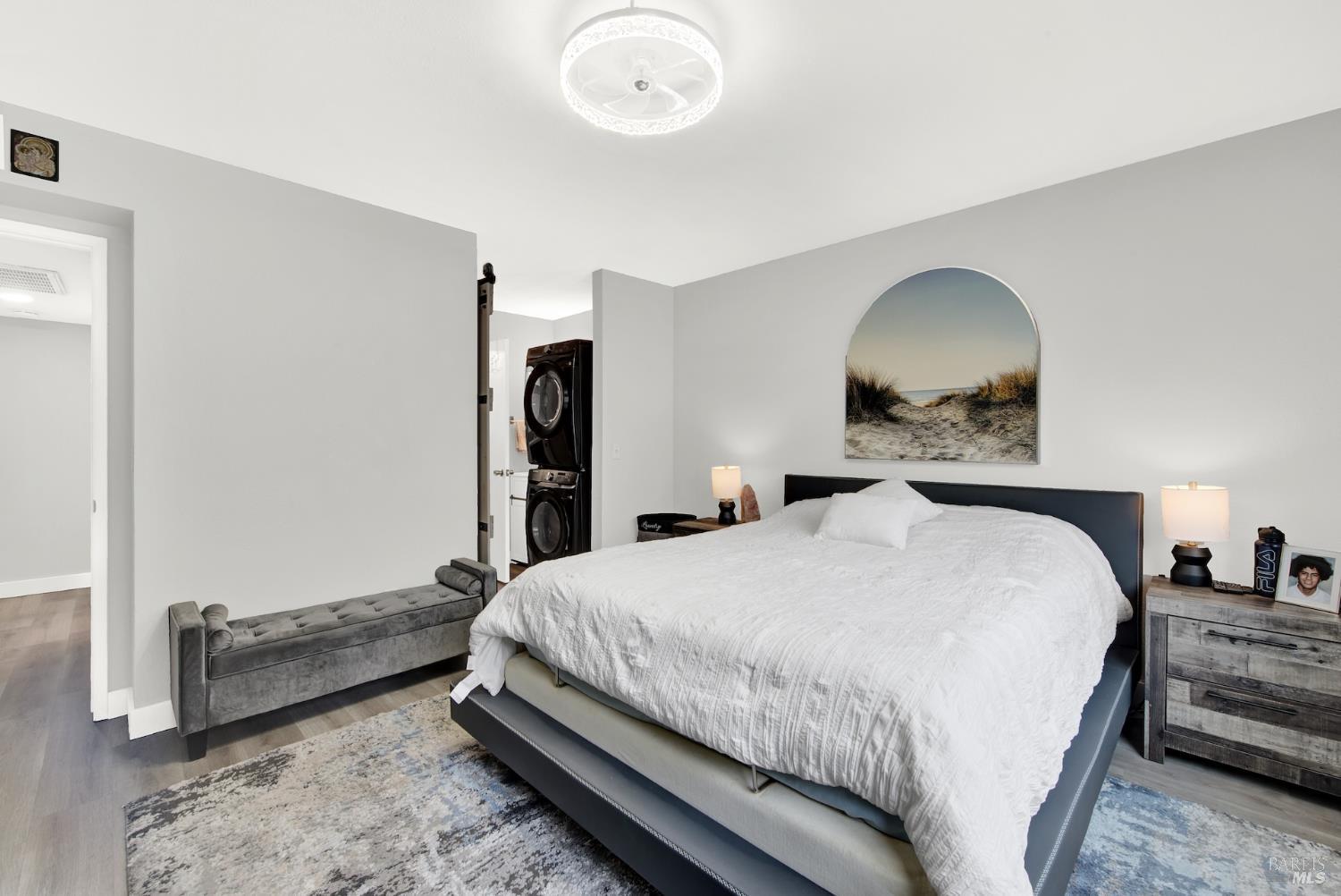 216 Apollo, Unit 7 Hercules, CA 94547 - Photo 19 of 29 a bedroom with a bed and a chandelier