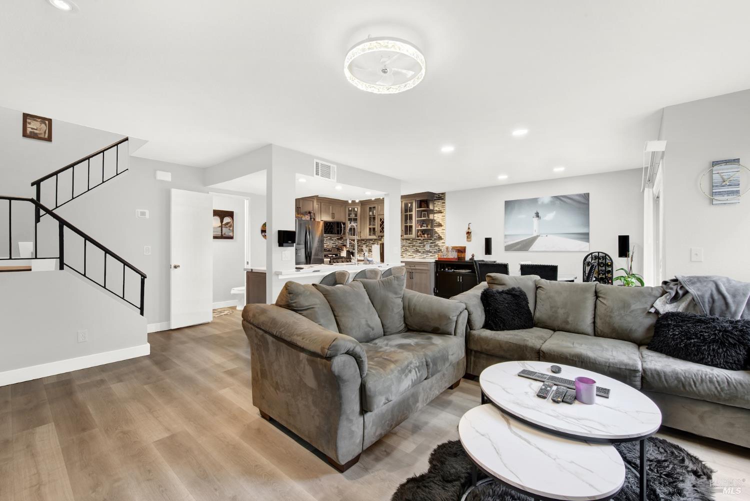 216 Apollo, Unit 7 Hercules, CA 94547 - Photo 6 of 29 a living room with furniture and a dining table with wooden floor