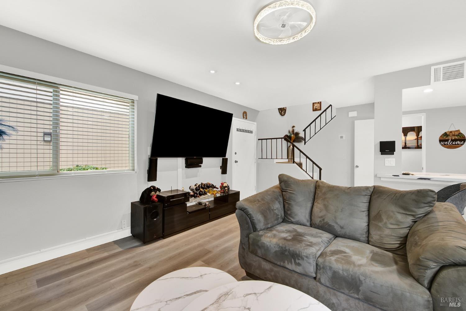 216 Apollo, Unit 7 Hercules, CA 94547 - Photo 8 of 29 a living room with furniture and a flat screen tv